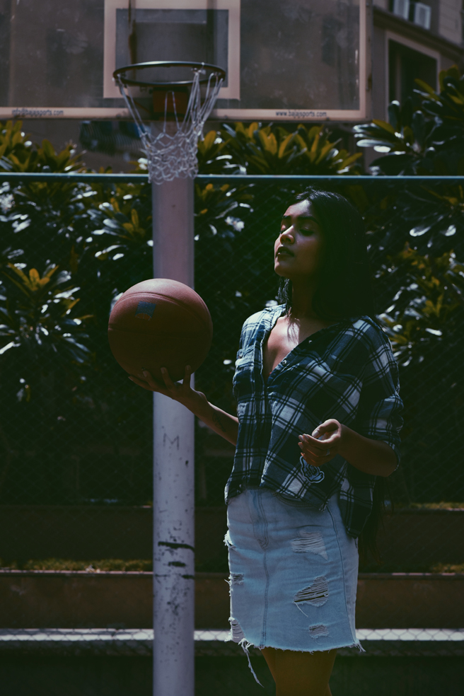 Indian model Palak Singhal photographed on a basketball court wearing a blue denims and a checked shirt | India Models