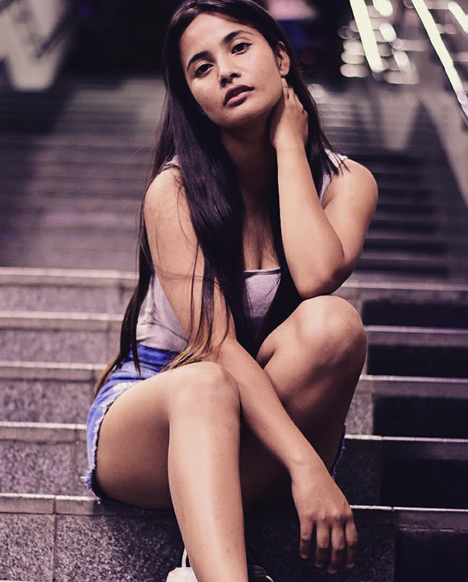 Indian Model modeling portfolio wearing a white top with denim shorts