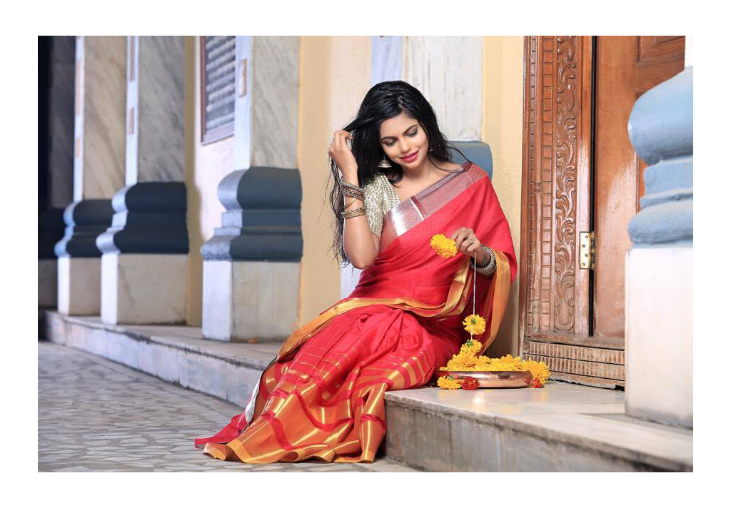 Indian Model Supriya Borshe wearing an ethnic orange saree.