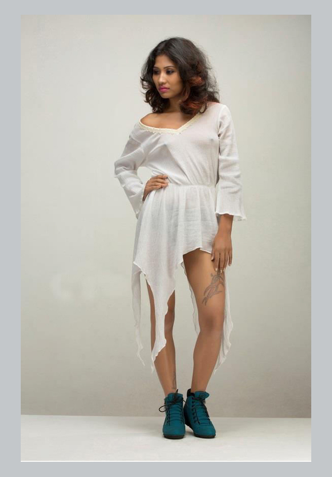 Gorgeous Indian actress Varsha Das photographed in a white dress and blue sneakers