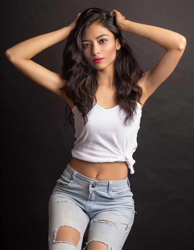 Stunning indian actress Anagha Phirke in a white top and blue jeans