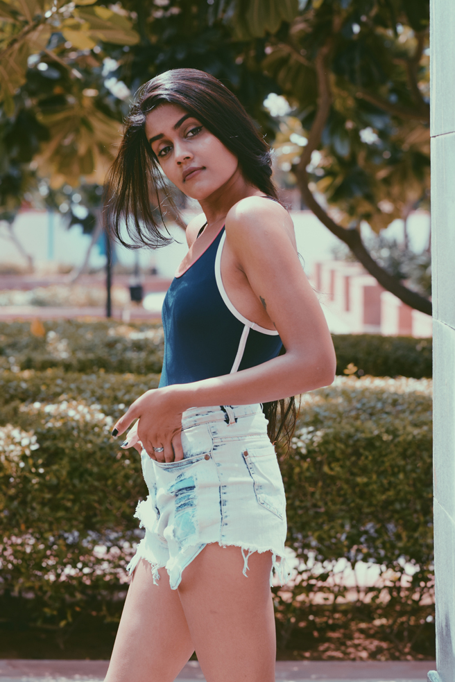 Indian model Palak Singal wearing a swimsuit with blue denim shorts